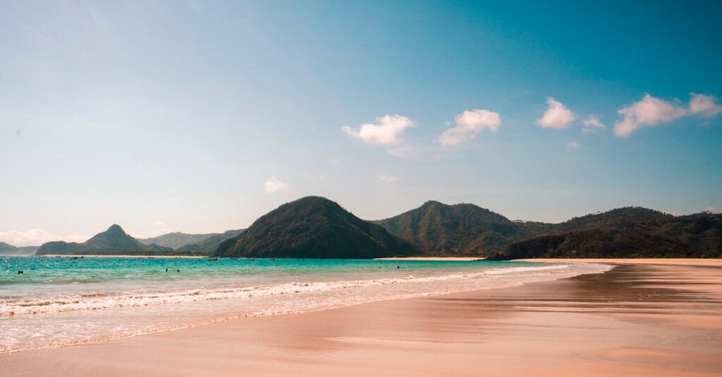 A tranquil beach view with mountains and turquoise water in West Nusa Tenggara, Indonesia.